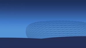 Stylized illustration of a modern stadium in blue tones, likely inspired by the Allianz Arena. The stadium sits in an open landscape under a clear sky with a gradient from dark to light blue.
